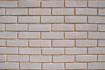 Obraz premium Wall of white bricks with yellow fugue