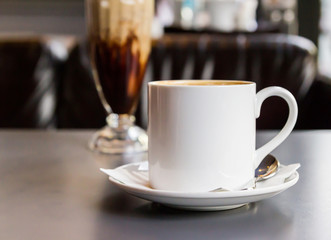 Coffee cup and saucer on table in coffee shop