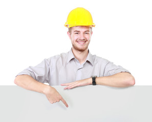 Young man holding blank billboard wearing hard hat