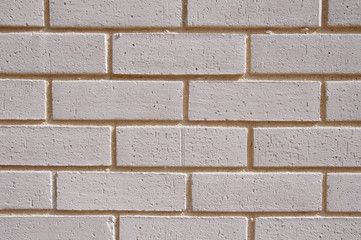 Wall of white bricks with yellow fugue