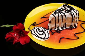 Tasty cake with cream, on black background © Africa Studio