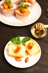Tasty pumpkin muffins on wooden table
