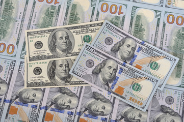 New and old banknotes on a background of hundred dollars