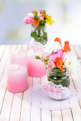 Beautiful bouquet of bright flowers in jars