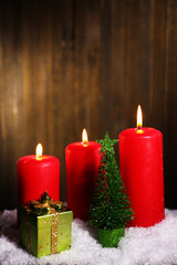 Burning candles on wooden background