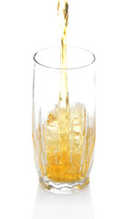Juice pouring into glass isolated on white