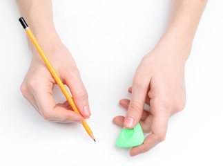 Human hands with pencil and erase rubber, isolated on white