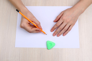 Human hands with pencil writing