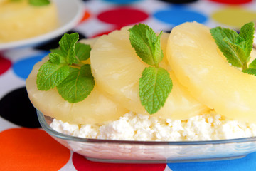 Bowl of tasty cottage cheese with pineapple, close up