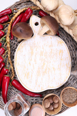 Different spices with blank cutting board, close up
