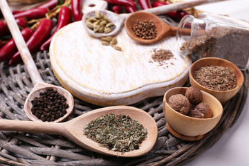 Different spices with blank cutting board, close up