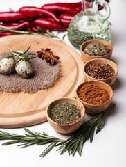 Different spices and cutting board, isolated on white