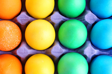 Colorful Easter eggs in tray close up