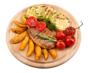 Grilled steak with fried potato pieces and grilled vegetables