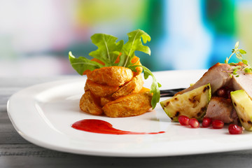 Grilled meat  with fried potato and marrow pieces and