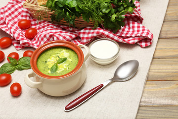 Tasty soup in saucepan on wooden table, close up