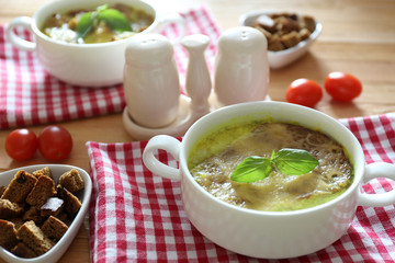 Tasty soup in saucepans on wooden table, close up