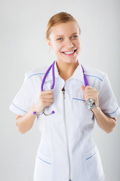 Smiling medical doctor woman with stethoscope. Isolated over whi