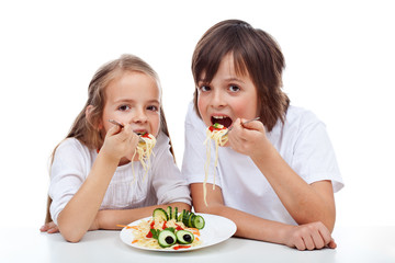 Kids eating a pasta dish
