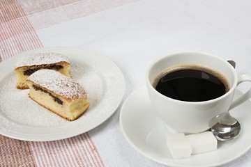 Bun filled with poppy seeds served with a cup of coffee