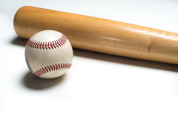 Wooden baseball bat and ball on white