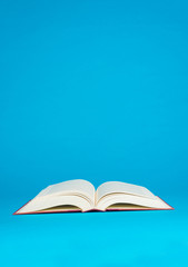 An open book on a blue background