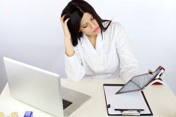 Doctor feeling tired about working with technology
