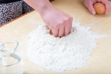 Girl is mixing the water and flour