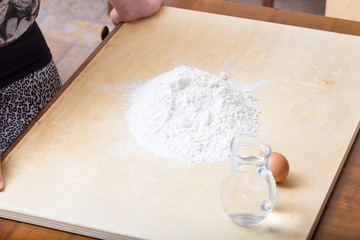 Girl is watching the flour on the table