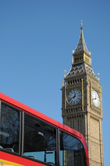 Fototapeta na wymiar Red bus passing Big Ben in Westminster, London