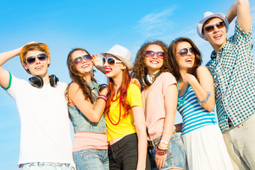 group of young people wearing sunglasses and hat