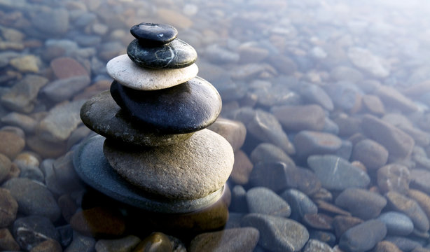 Zen Balancing Rocks on Pebbles Covered with Water