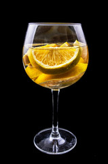 orange slices on a glass on wine with dark background