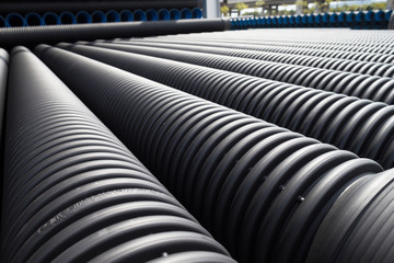 Fototapeta premium Close up of black plastic pipes with diminishing perspective