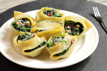 Pasta shells stuffed with spinach, raisins and pine nuts