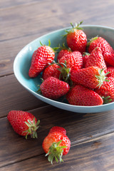 close up of strawberry on wooden background
