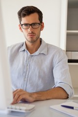 Fototapeta premium Casual businessman working at his desk