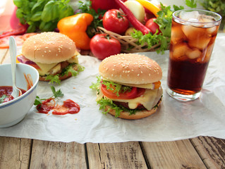 Homemade hamburgers with fresh vegetables and cold drink