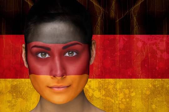 Composite image of beautiful football fan in face paint