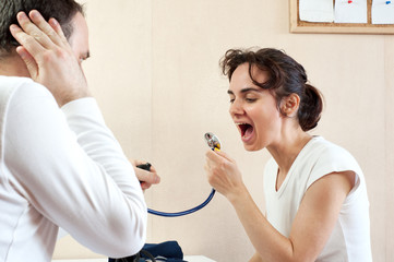 Young woman screaming in doctor's stethoscope