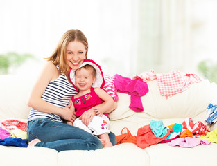 happy  Mother and baby girl with clothes ready for traveling on