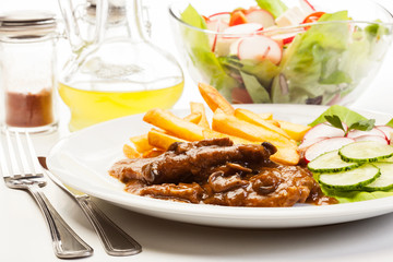 Pork chop with sauce, mushrooms and chips