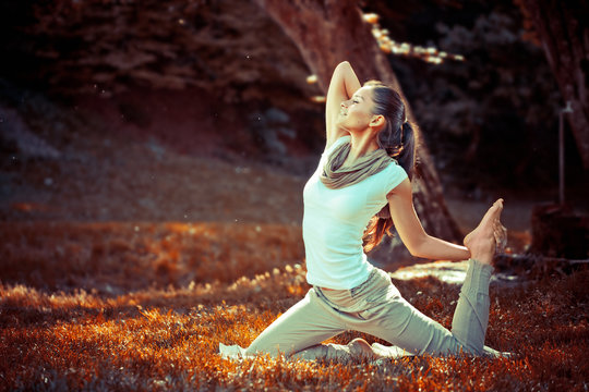 Young Attractive Woman Doing Yoga In Nature