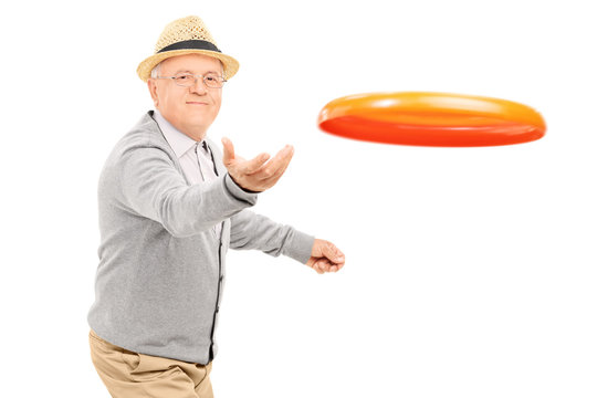 Senior man throwing a Frisbee disk
