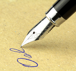 Fountain pen writing on the paper, macro shot.