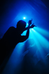 Silhouets of a people dandin in a nightclub