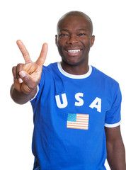 Attractive guy from USA showing victory sign