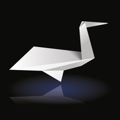 White origami bird on dark background