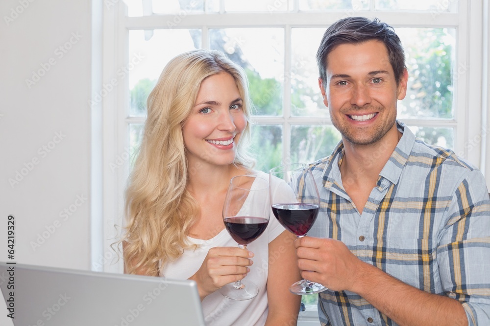 Wall mural loving young couple with wine glasses at home