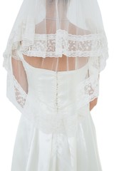 Woman in wedding dress and veil over white background